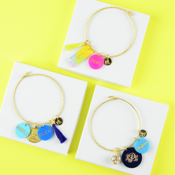 Moon and Lola - Nora Bangle Bundle with a variety of charms on a yellow background