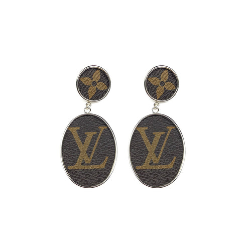 Leone Drop Post earrings feature the classic monogram canvas print inset into a gold or silver bezel setting.